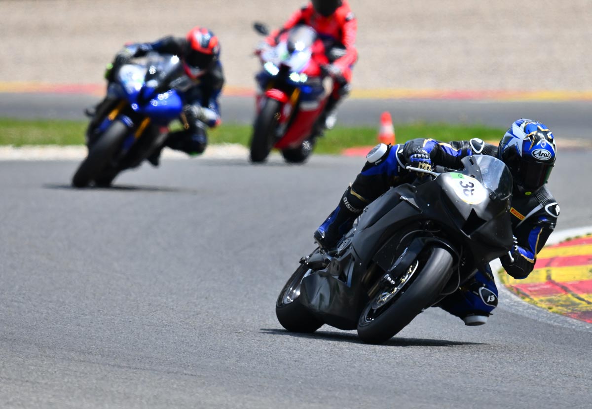 Cody N. Gayer on his motorcycle in a race with two other motorcyclists